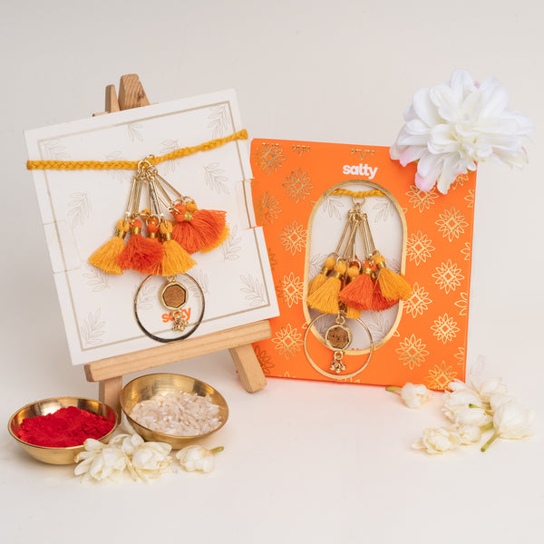 Orange Tassel And Enamel Lumba Bandhan Rakhi For Bhabhi