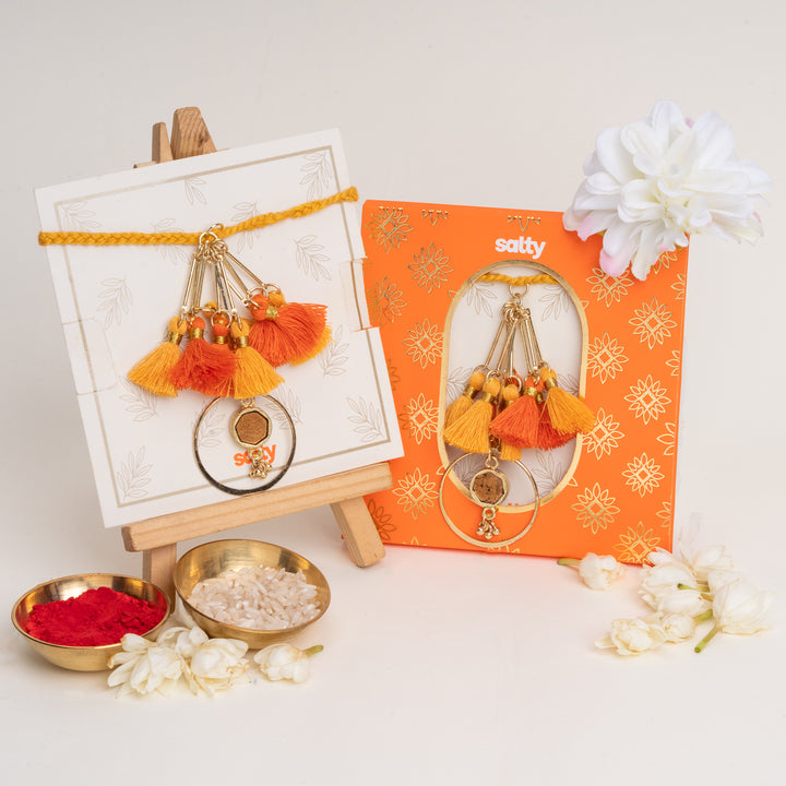 Orange Tassel And Enamel Lumba Bandhan Rakhi For Bhabhi