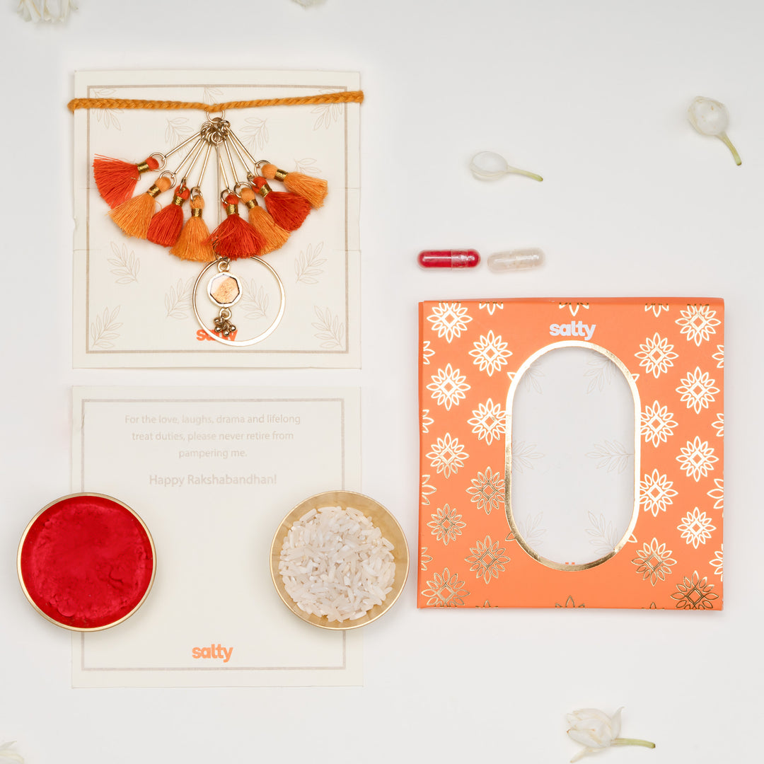 Orange Tassel And Enamel Lumba Bandhan Rakhi For Bhabhi