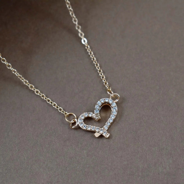 Criss cross studded heart gold necklace