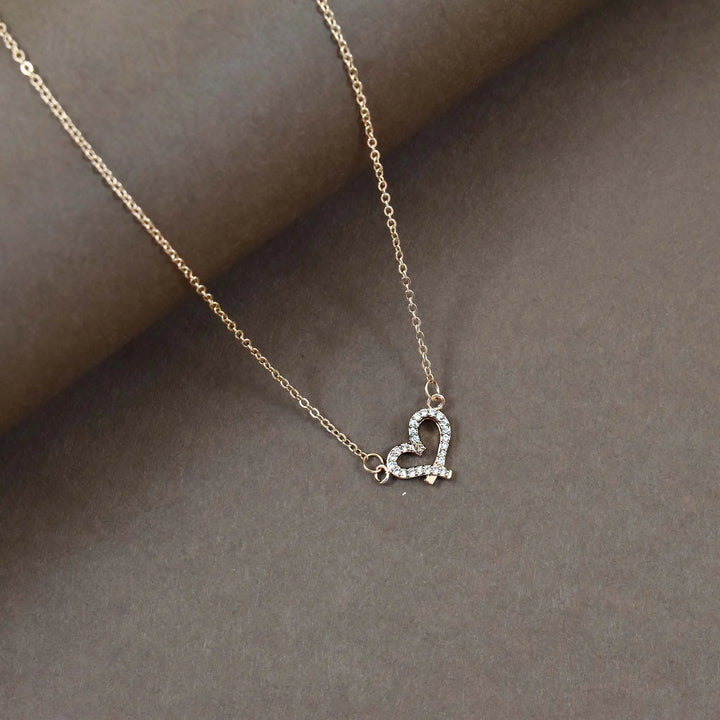Criss cross studded heart gold necklace